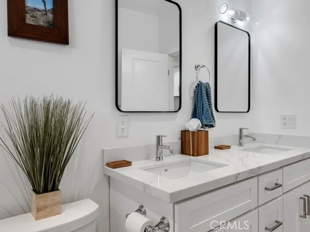 a living room with furniture fireplace and large windows