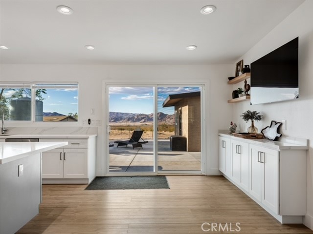 30280 Santa Rosa Road Lucerne Valley, CA 92356 - Photo 39 of 61 a open kitchen with stainless steel appliances kitchen island granite countertop a refrigerator and cabinets