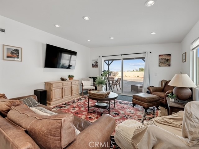 30280 Santa Rosa Road Lucerne Valley, CA 92356 - Photo 48 of 61 a living room with furniture a flat screen tv and a window