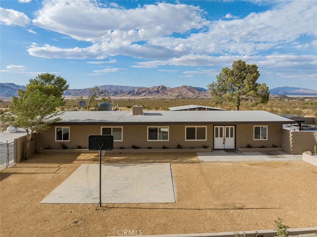 30280 Santa Rosa Road Lucerne Valley, CA 92356 - Photo 58 of 61 a front view of house with yard and trees in the background