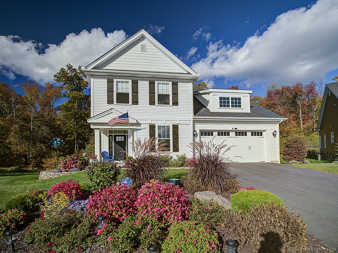 12 Woodland Path, Unit 12 Beacon Falls, CT 06403 - Photo 1 of 1 a front view of house with the garden in the background