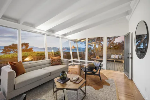 a living room with furniture and a floor to ceiling window