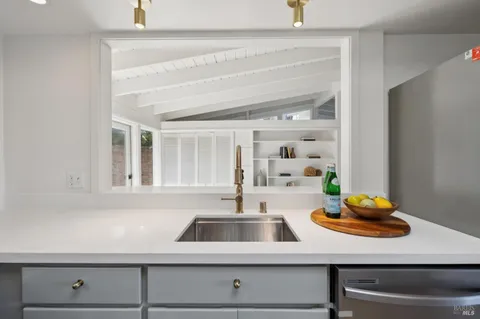 a kitchen with a sink cabinets and window