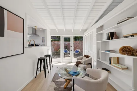 a dining room with furniture and a floor to ceiling window