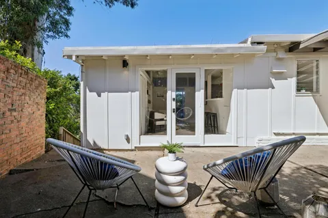 a view of a patio with a table and chairs