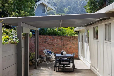 a backyard of a house with outdoor seating