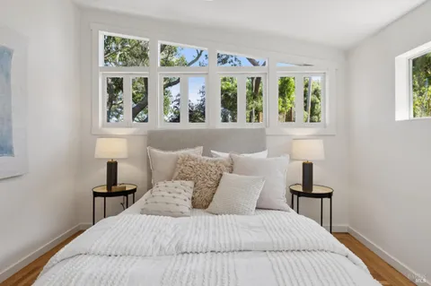 a bedroom with a large bed and a window