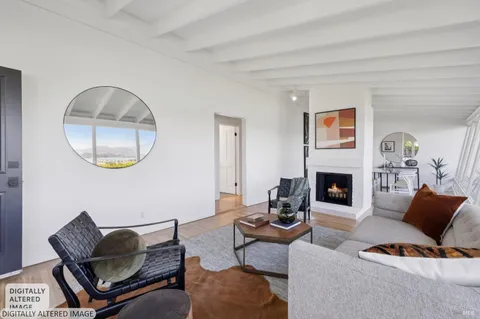 a living room with furniture a fireplace and a large mirror