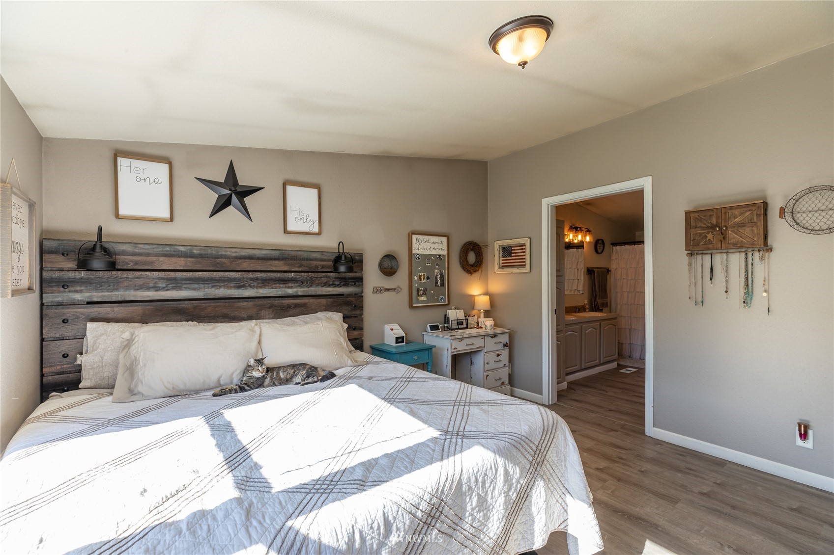 57 Alvarado Road Tonasket, WA 98855 - Photo 19 of 39 a bedroom with a bed and wooden floor