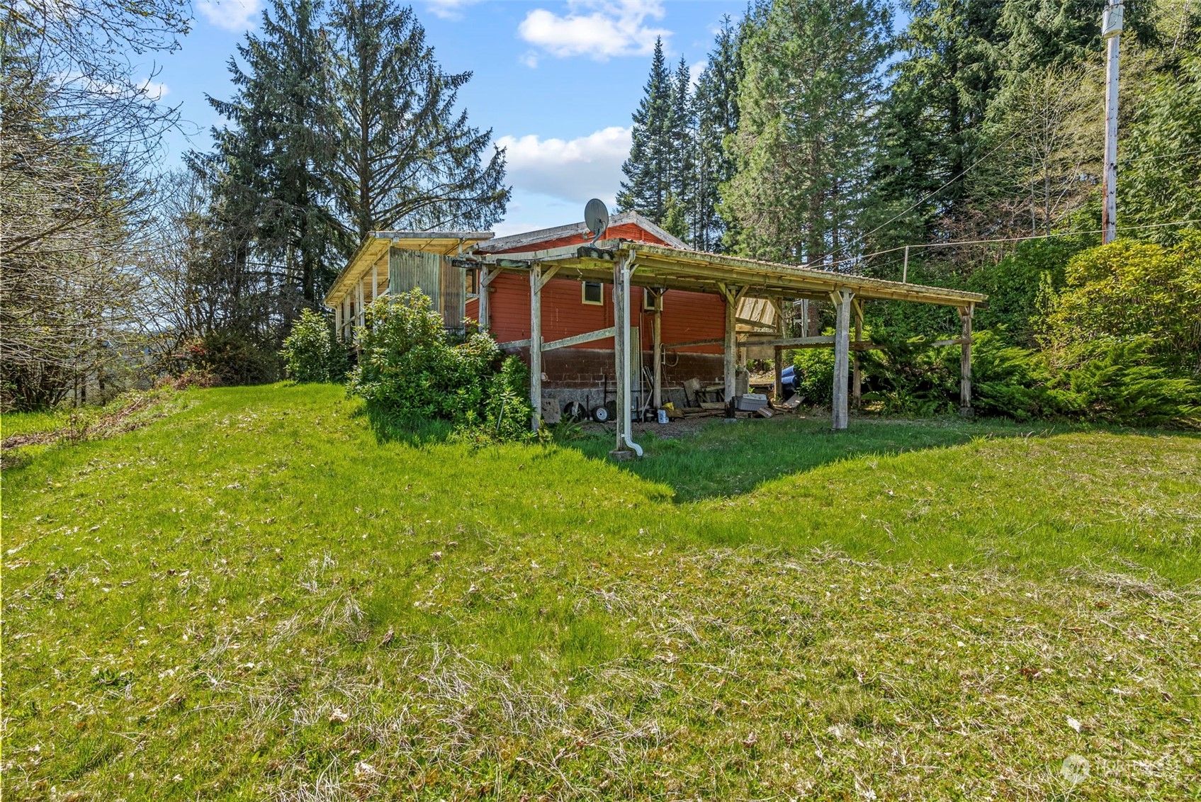 273 Middle Valley Road Skamokawa, WA 98647 - Photo 13 of 30 a view of a house with a big yard plants and large trees