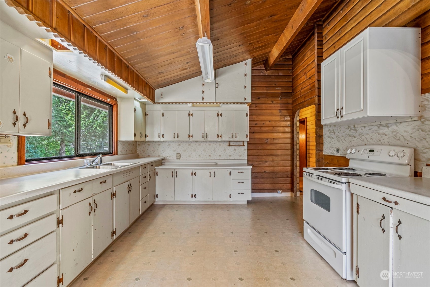 273 Middle Valley Road Skamokawa, WA 98647 - Photo 14 of 30 a kitchen with white cabinets and white appliances