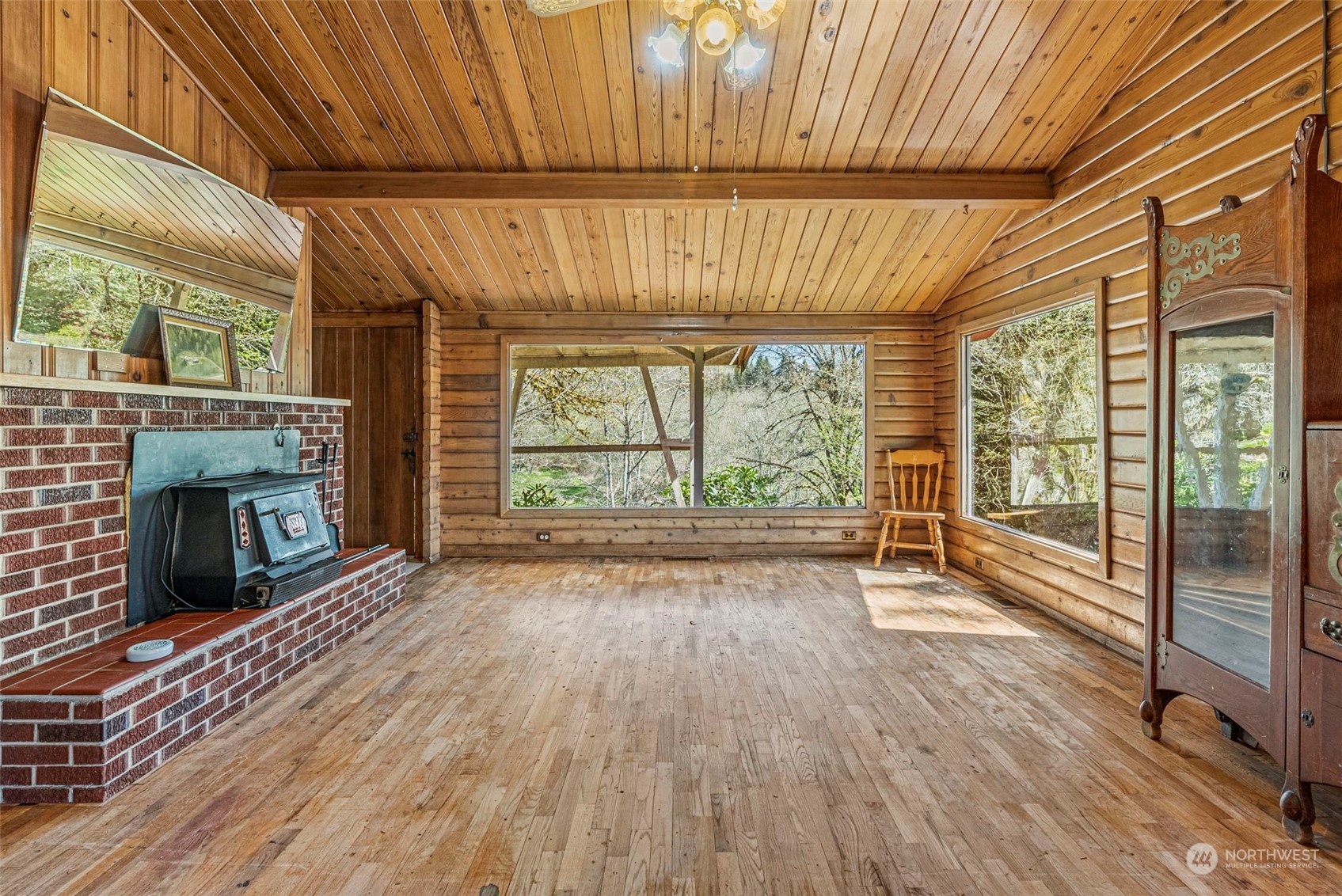 273 Middle Valley Road Skamokawa, WA 98647 - Photo 18 of 30 a view of an empty room with wooden floor and a window
