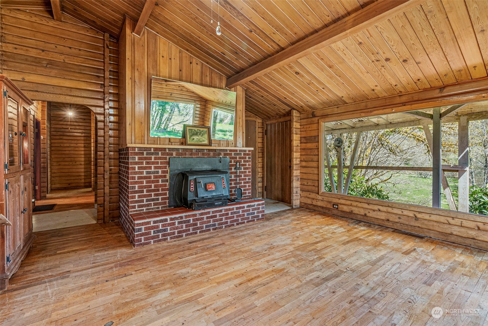 273 Middle Valley Road Skamokawa, WA 98647 - Photo 19 of 30 a view of empty room with wooden floor and fireplace