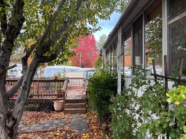 a view of house with backyard and sitting area