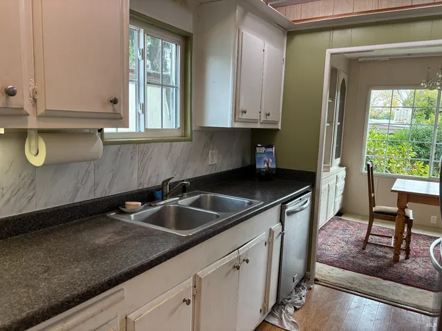 a kitchen with granite countertop a sink and a stove