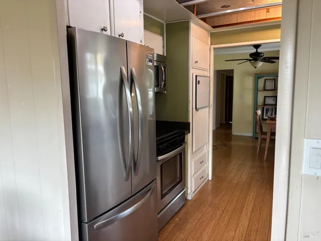 a metallic refrigerator freezer sitting in a kitchen