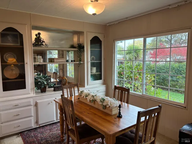 a view of a dining room with furniture window and outside view