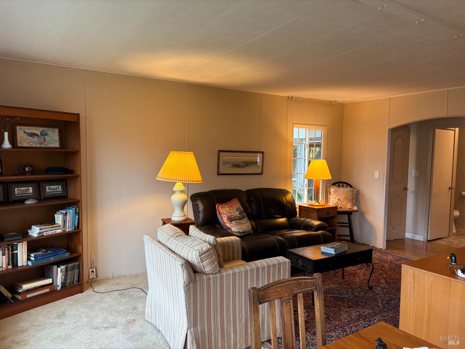 10 Oceano Place Novato, CA 94949 - Photo 7 of 20 a living room with furniture a rug and a wall painting