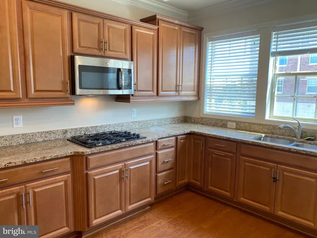 a kitchen with wooden cabinets and a stove top oven