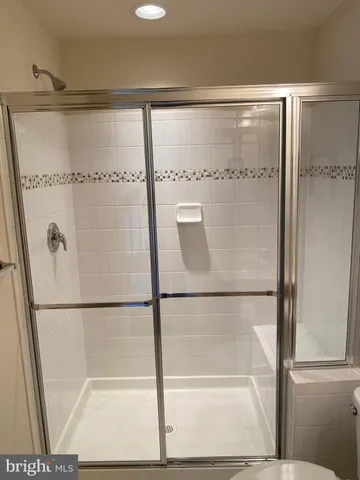 a bathroom with a glass shower door