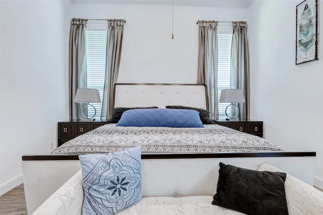 a bathroom with a double vanity sink a mirror and a bathtub