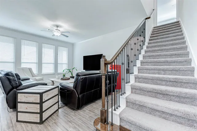 a living room with furniture a air conditioner and a rug