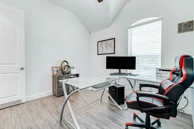 a view of a workspace with furniture and wooden floor
