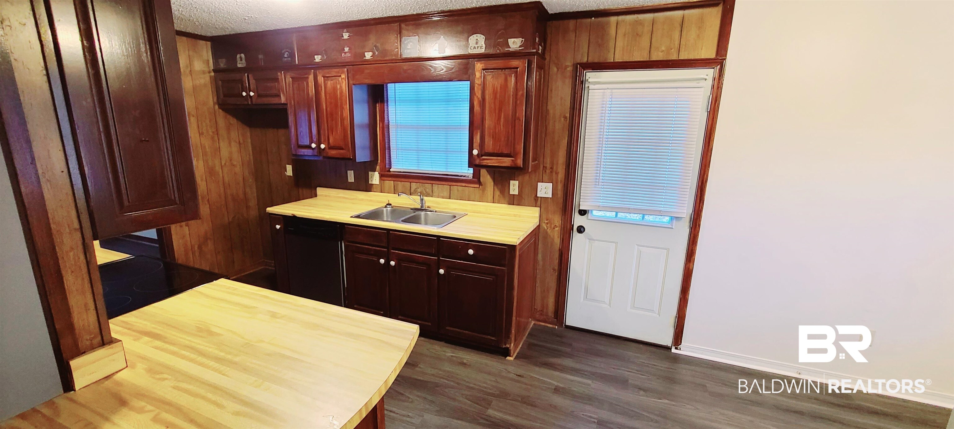 5305 Wilhelm Drive Mobile, AL 36618 - Photo 5 of 16 Kitchen featuring dark wood-style flooring, a sink, light countertops, black dishwasher, and a textured ceiling