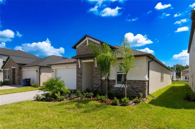 a view of a house with a swimming pool and a yard