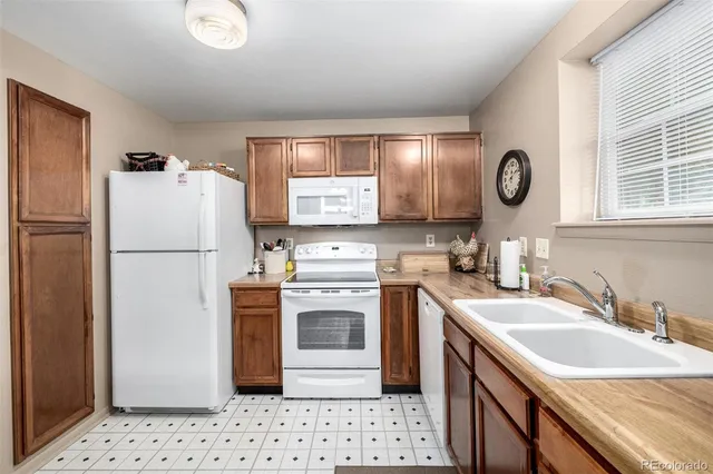 a kitchen with a sink a stove and refrigerator