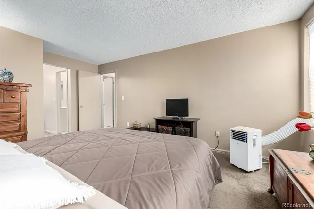 a bedroom with a bed and a television