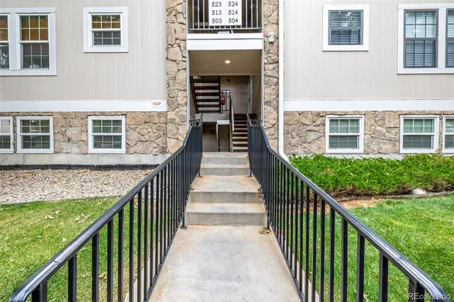 a view of a balcony with wooden floor and fence
