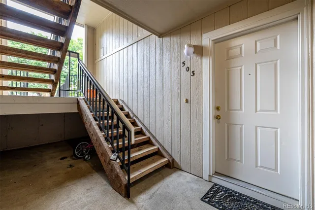 a view of a hallway with windows and stairs