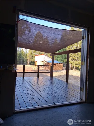 a view of a hallway with wooden floor and entryway