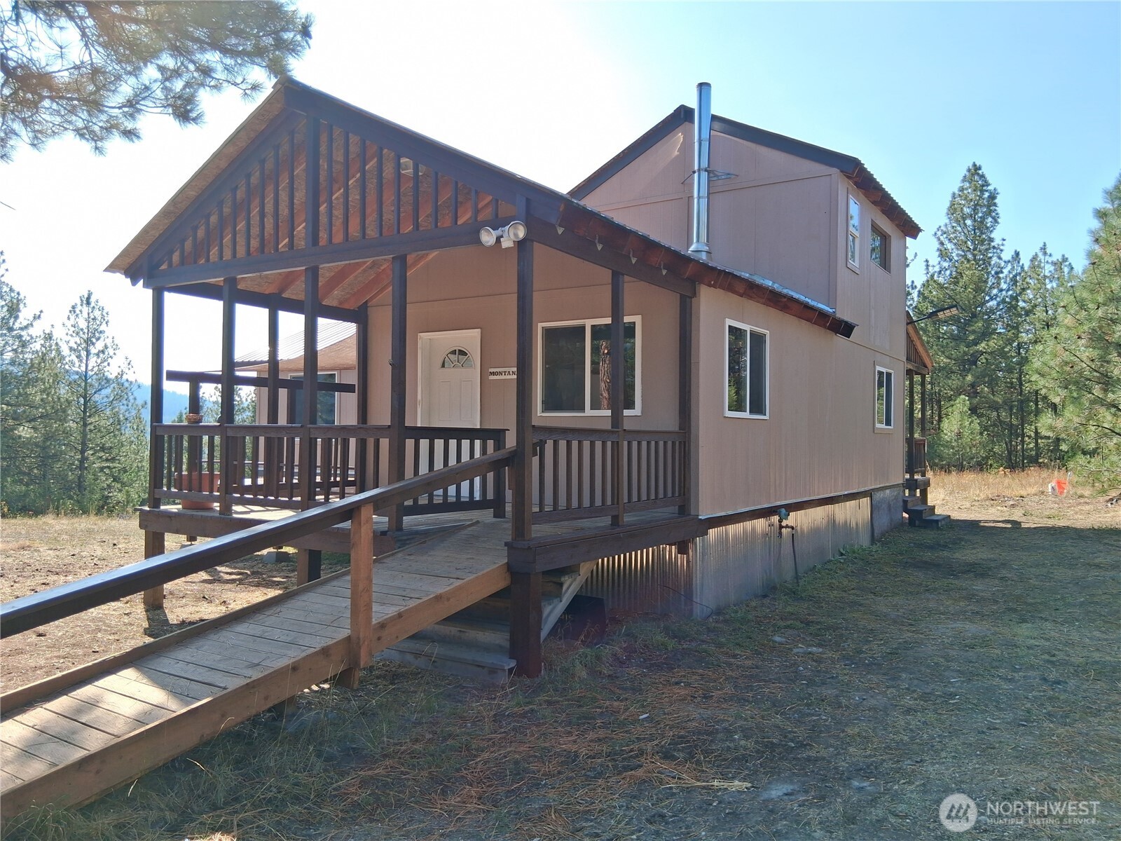 100 Turner Lake Road North Tonasket, WA 98855 - Photo 2 of 39 a porch with a table and chairs
