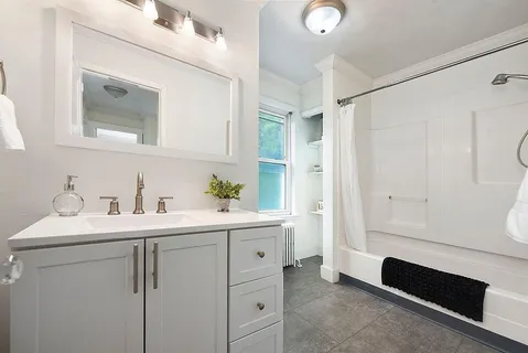 a bathroom with a toilet a sink and a mirror