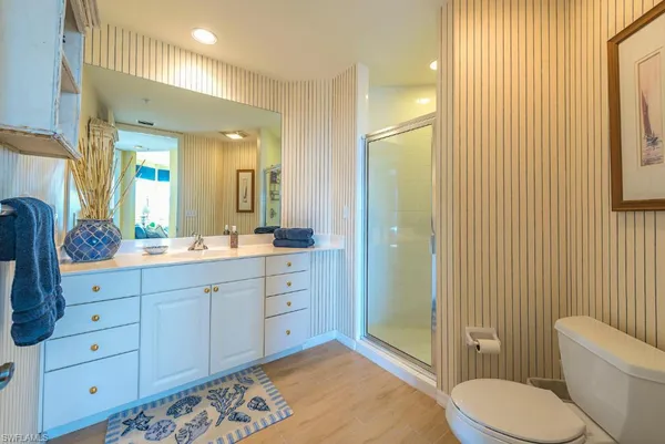a spacious bathroom with a granite countertop sink toilet and shower