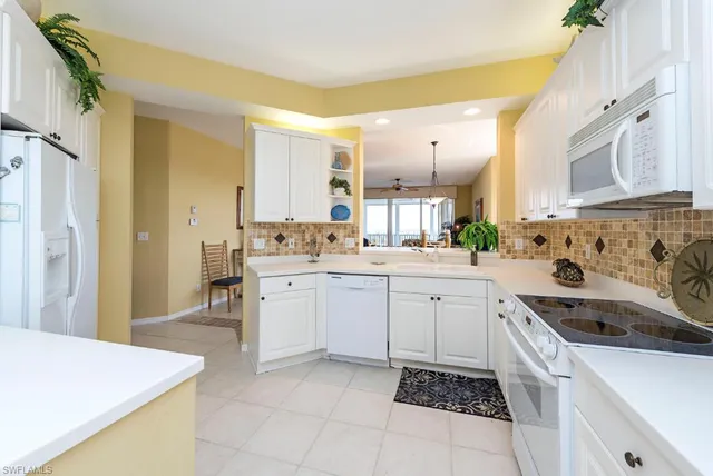 a kitchen with a sink stove top oven and cabinets