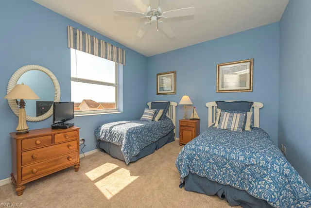 a bedroom with two beds and a dresser