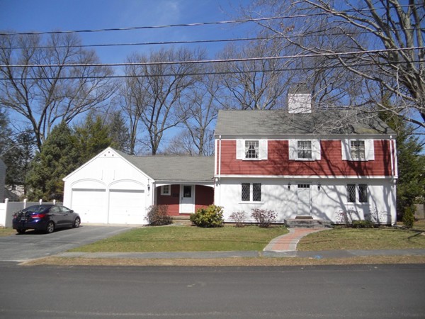 41 Colby Street Needham, MA 02492 - Photo 12 of 12 a front view of a house with a yard and garage