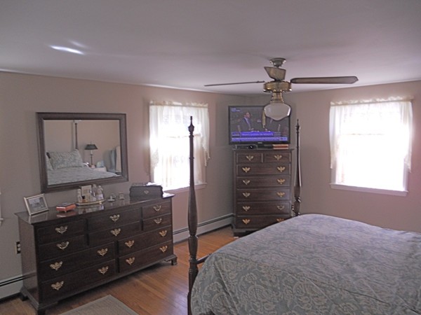 41 Colby Street Needham, MA 02492 - Photo 10 of 12 a bedroom with a bed and a mirror on dresser