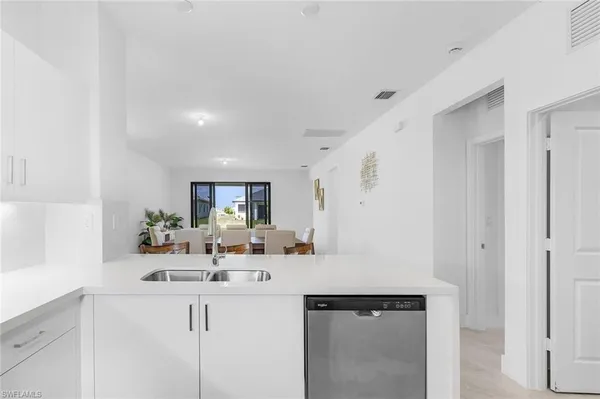 a kitchen with stainless steel appliances a sink stove and refrigerator