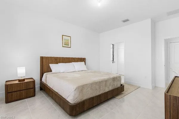 a bedroom with a bed and a night stand