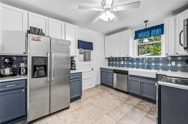 a kitchen with a refrigerator sink and stove