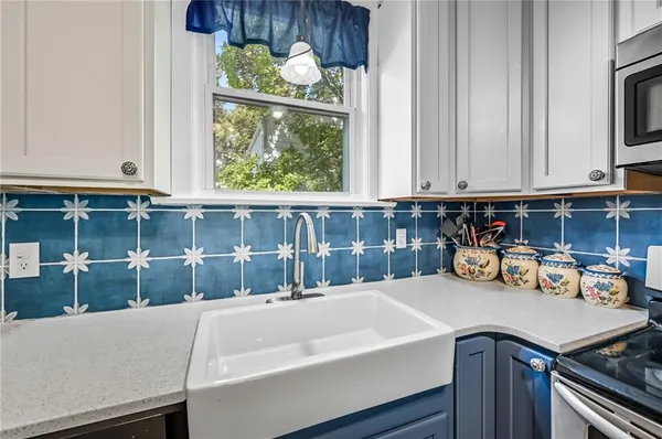 a kitchen with a sink and cabinets