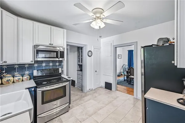 a kitchen with stainless steel appliances a stove a microwave and cabinets