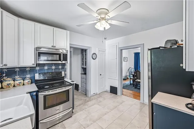 a kitchen with stainless steel appliances a stove a microwave and cabinets