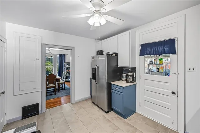 a kitchen with stainless steel appliances granite countertop a refrigerator and a stove top oven