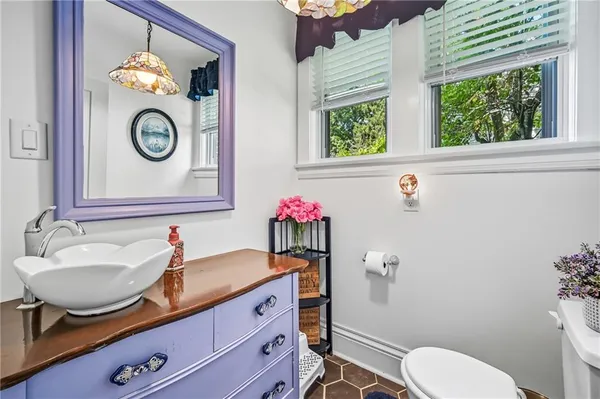 a bathroom with a sink mirror vanity and toilet
