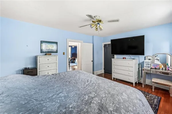 a bedroom with a bed and flat screen tv